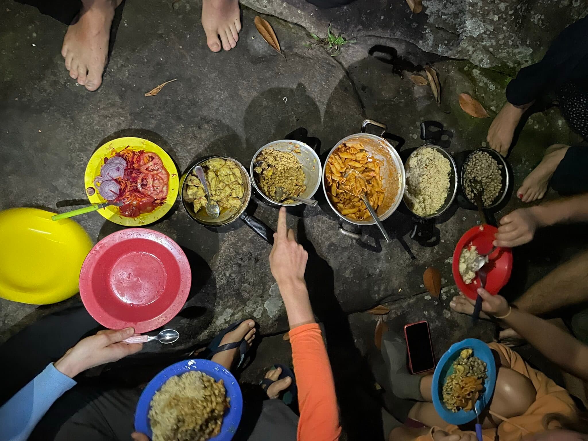 Pots of rice, beans and pasta served at base camp after dark